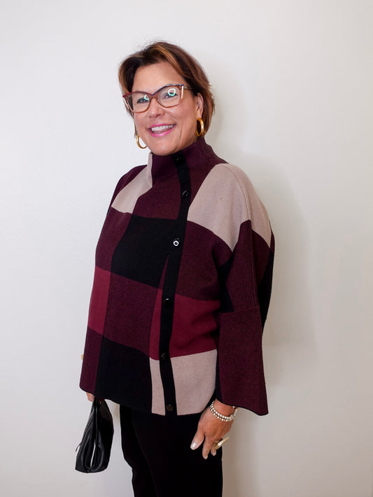 Woman wearing a checkered sweater against a white background