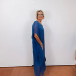 helen silk kaftan long dress featuring a sheer blue fabric and relaxed fit worn by model