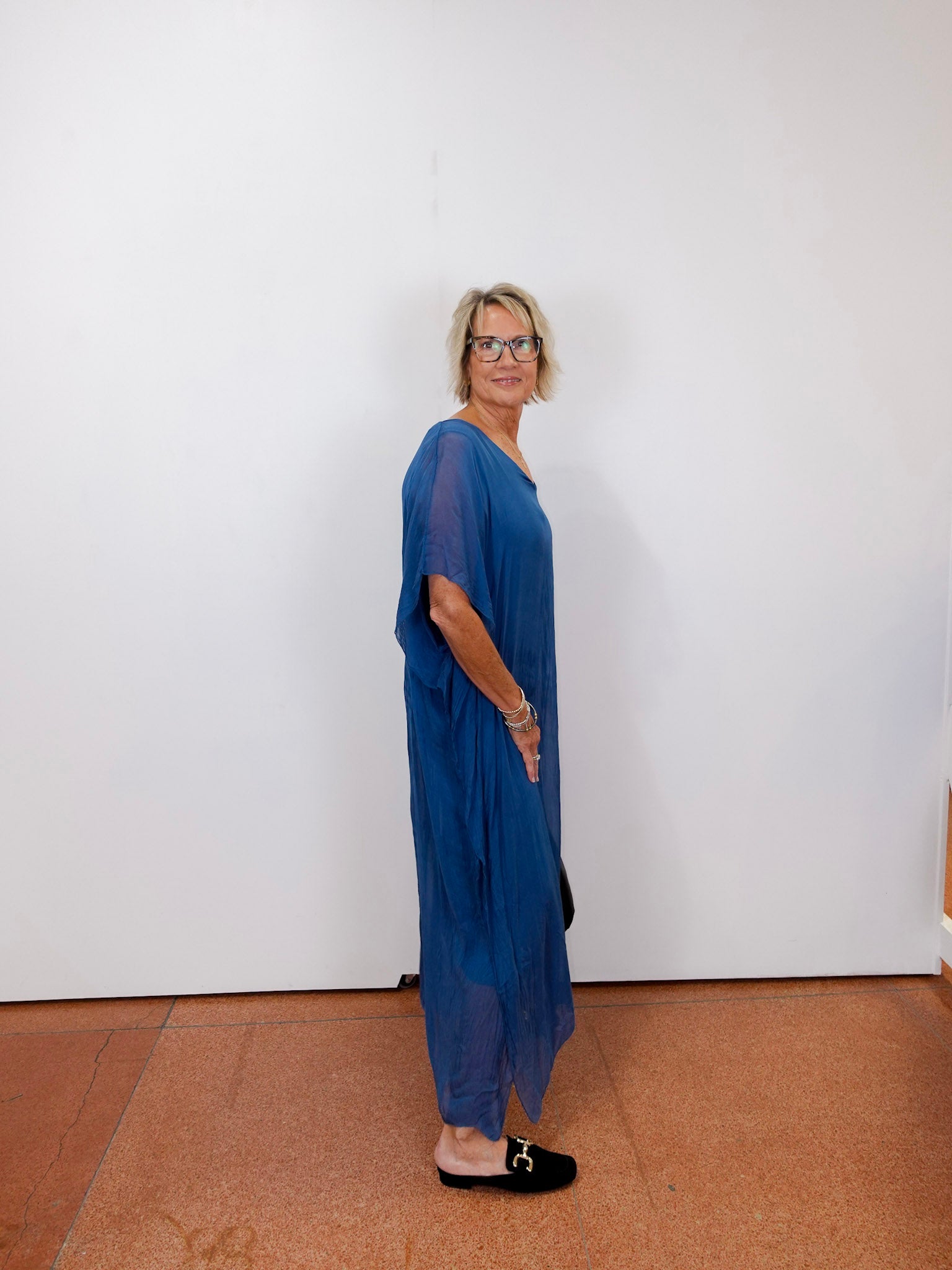 helen silk kaftan long dress featuring a sheer blue fabric and relaxed fit worn by model