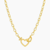 Gold necklace with a heart-shaped clasp on a white background
