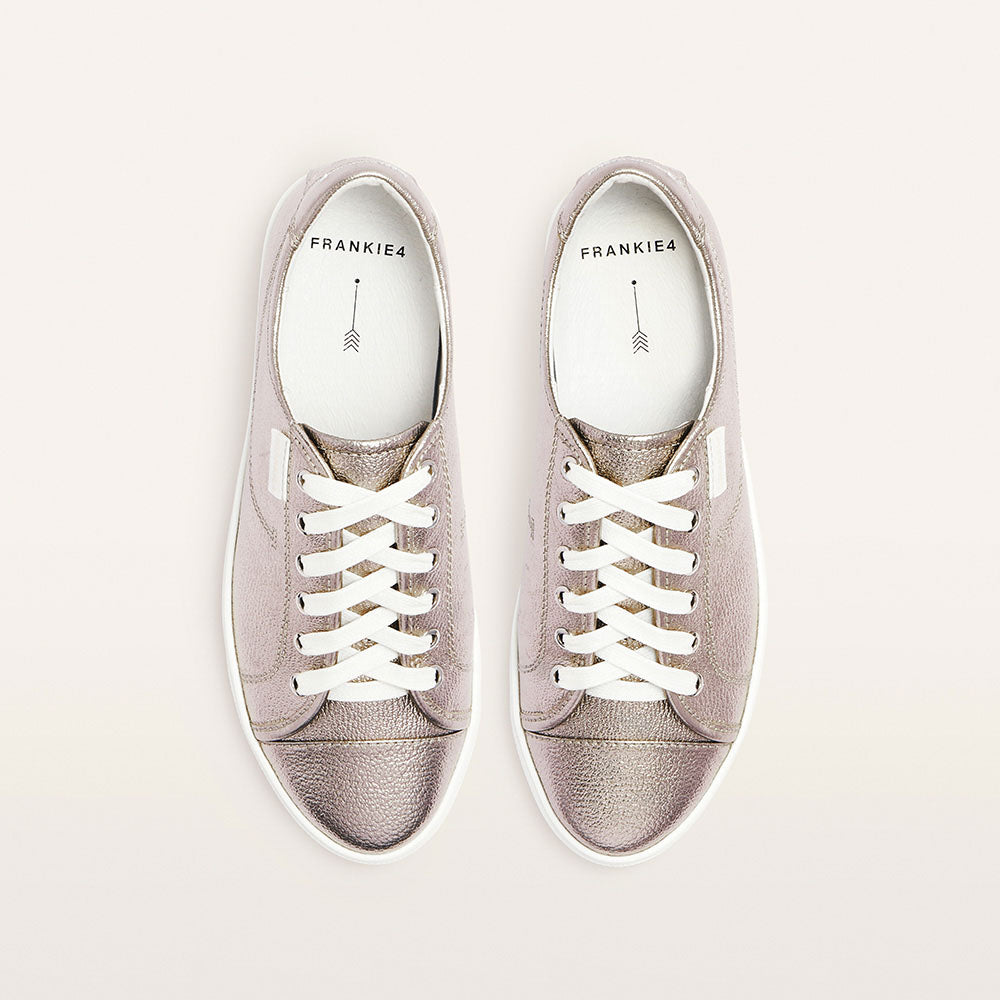 Pair of gray sneakers with white laces on a light gray background