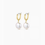 Gold hoop earrings with pearl drops on a white background