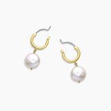 Gold hoop earrings with pearl drops on a white background