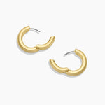 Gold hoop earrings on a white background