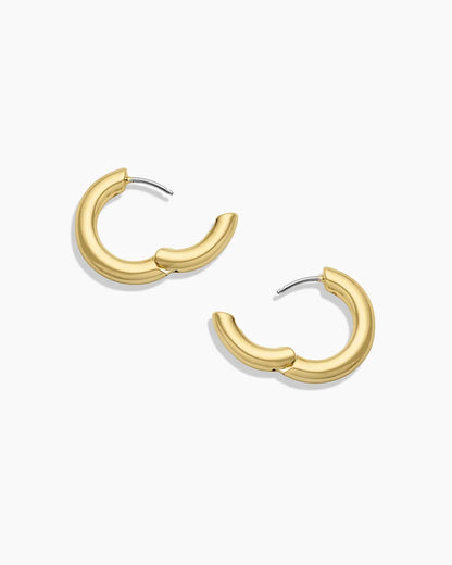 Gold hoop earrings on a white background