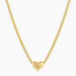 Gold heart-shaped pendant necklace on a white background