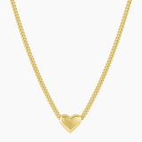 Gold heart-shaped pendant necklace on a white background