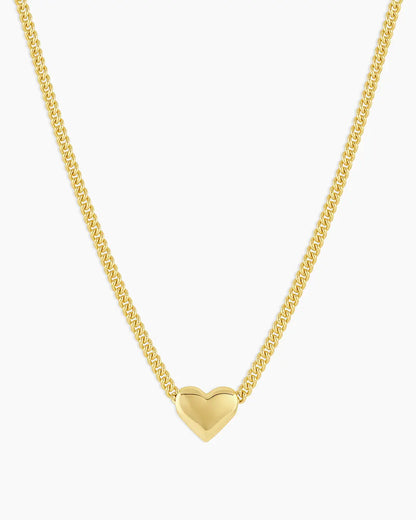 Gold heart-shaped pendant necklace on a white background