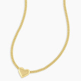 Gold heart-shaped pendant necklace on a white background