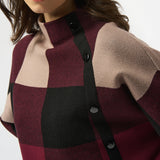 Close-up of a person wearing a checkered coat with a white background