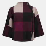 Plaid patterned blouse with a high collar on a white background