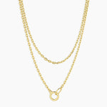 Two gold necklaces on a white background