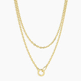 Two gold necklaces on a white background