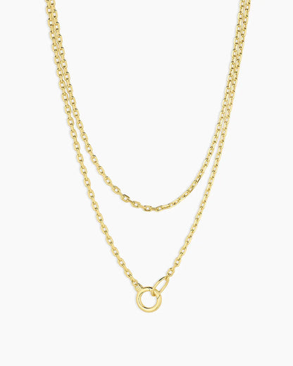 Two gold necklaces on a white background
