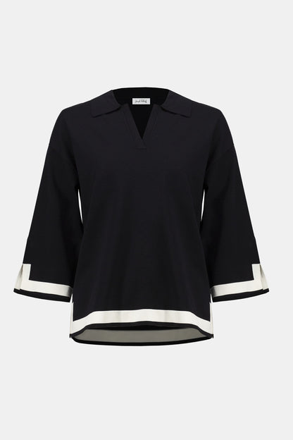 Black blouse with white trim on a white background
