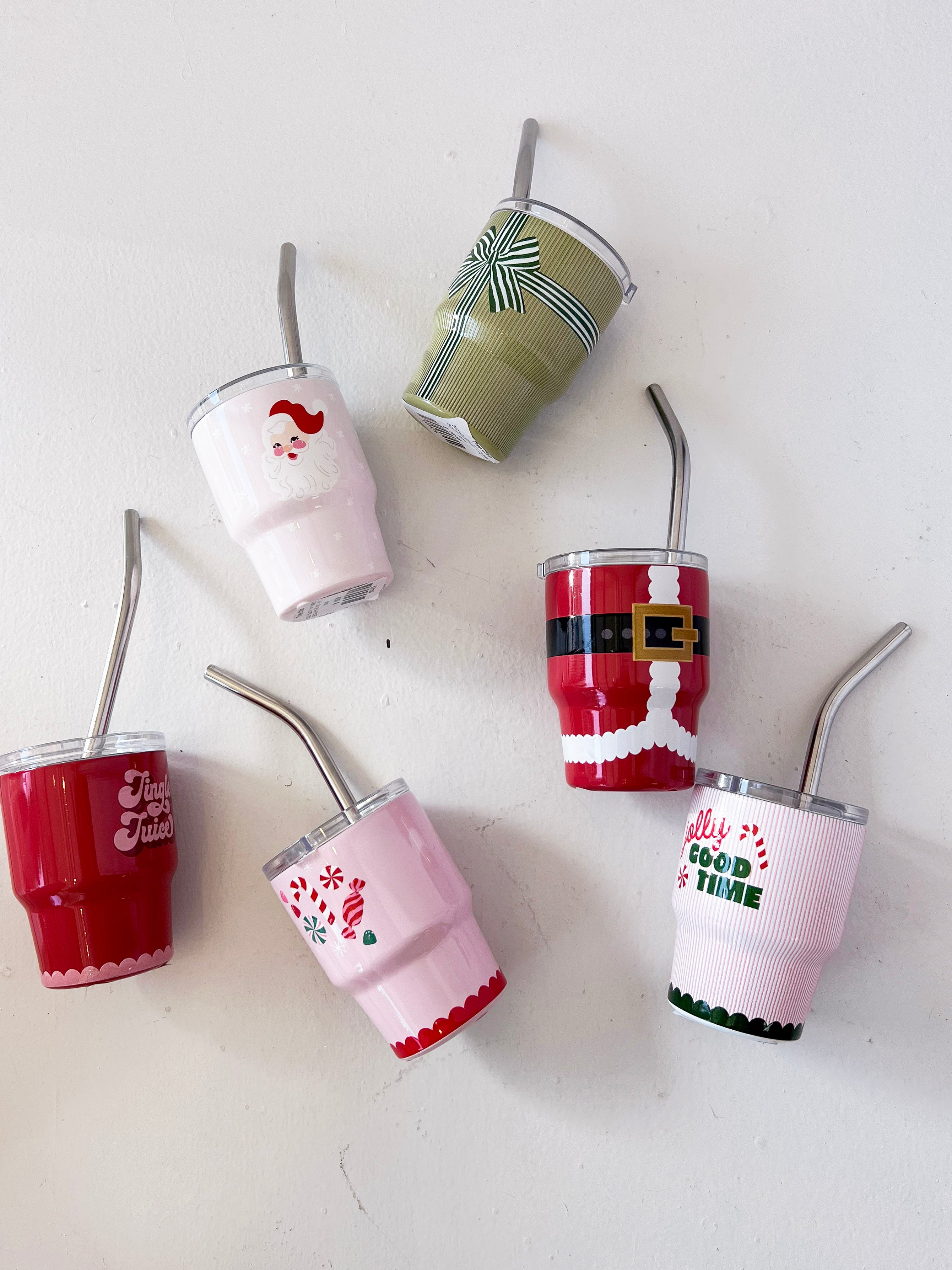 Set of colorful tumblers with straws on a white background