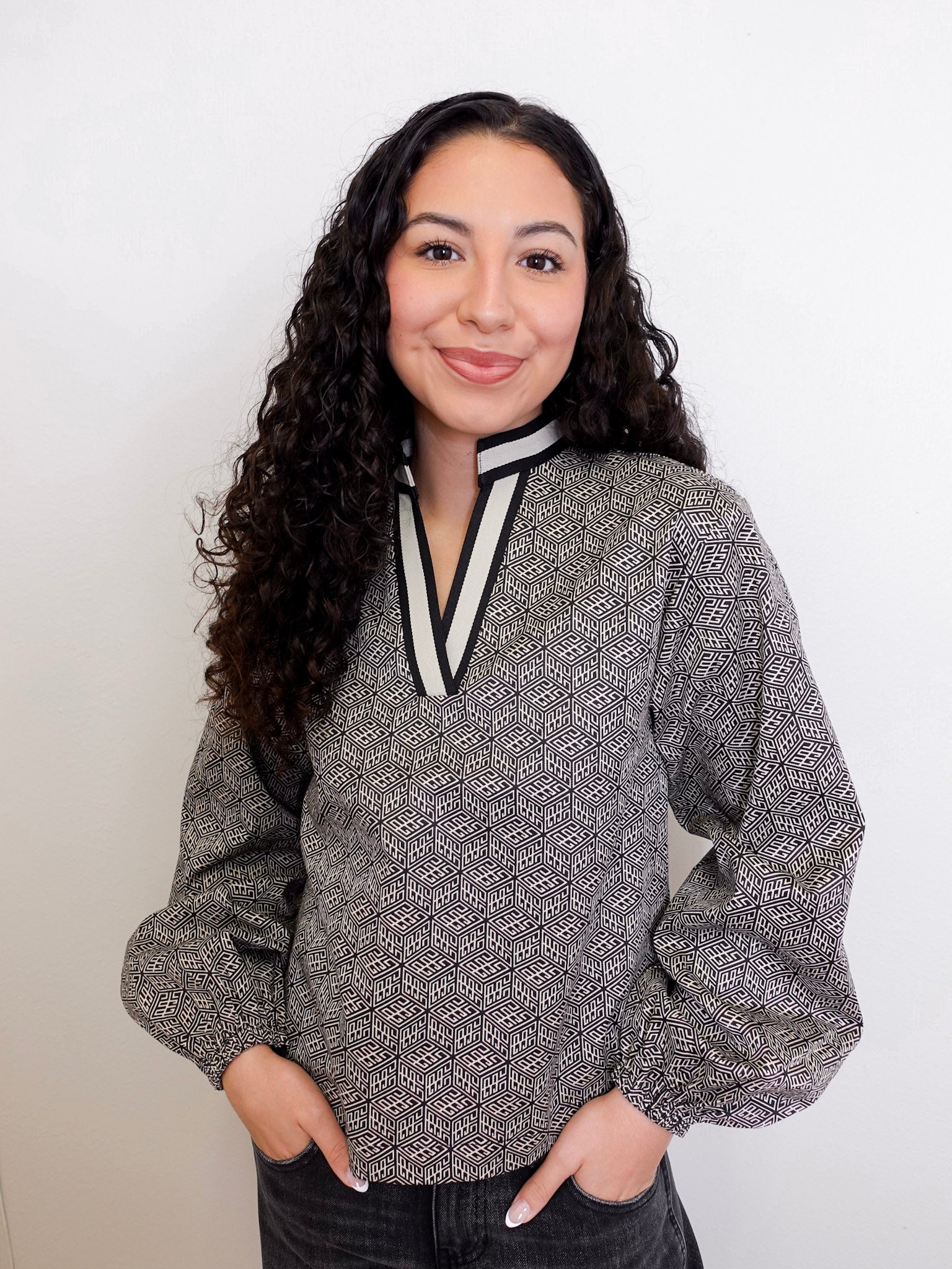 Woman wearing a patterned blouse with a white background