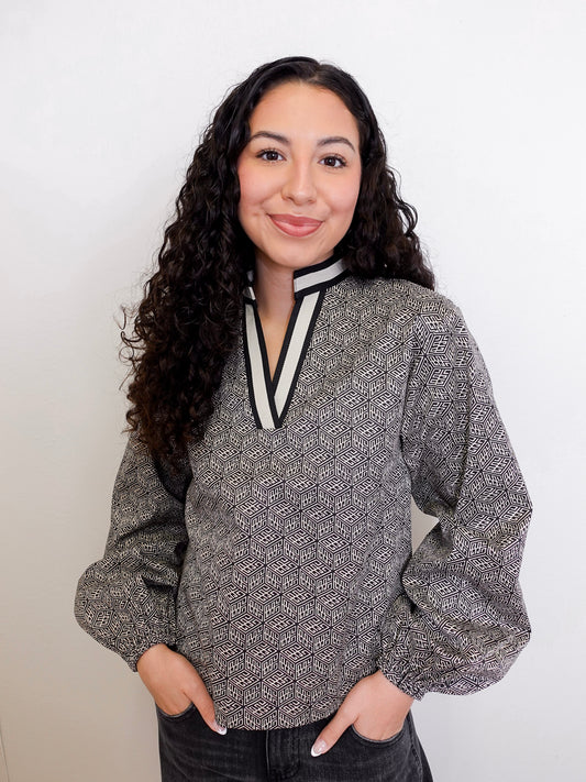 Woman wearing a patterned blouse with a white background