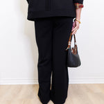 woman wearing a black pant against a white background 