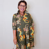 Woman wearing a patterned dress with a plain background