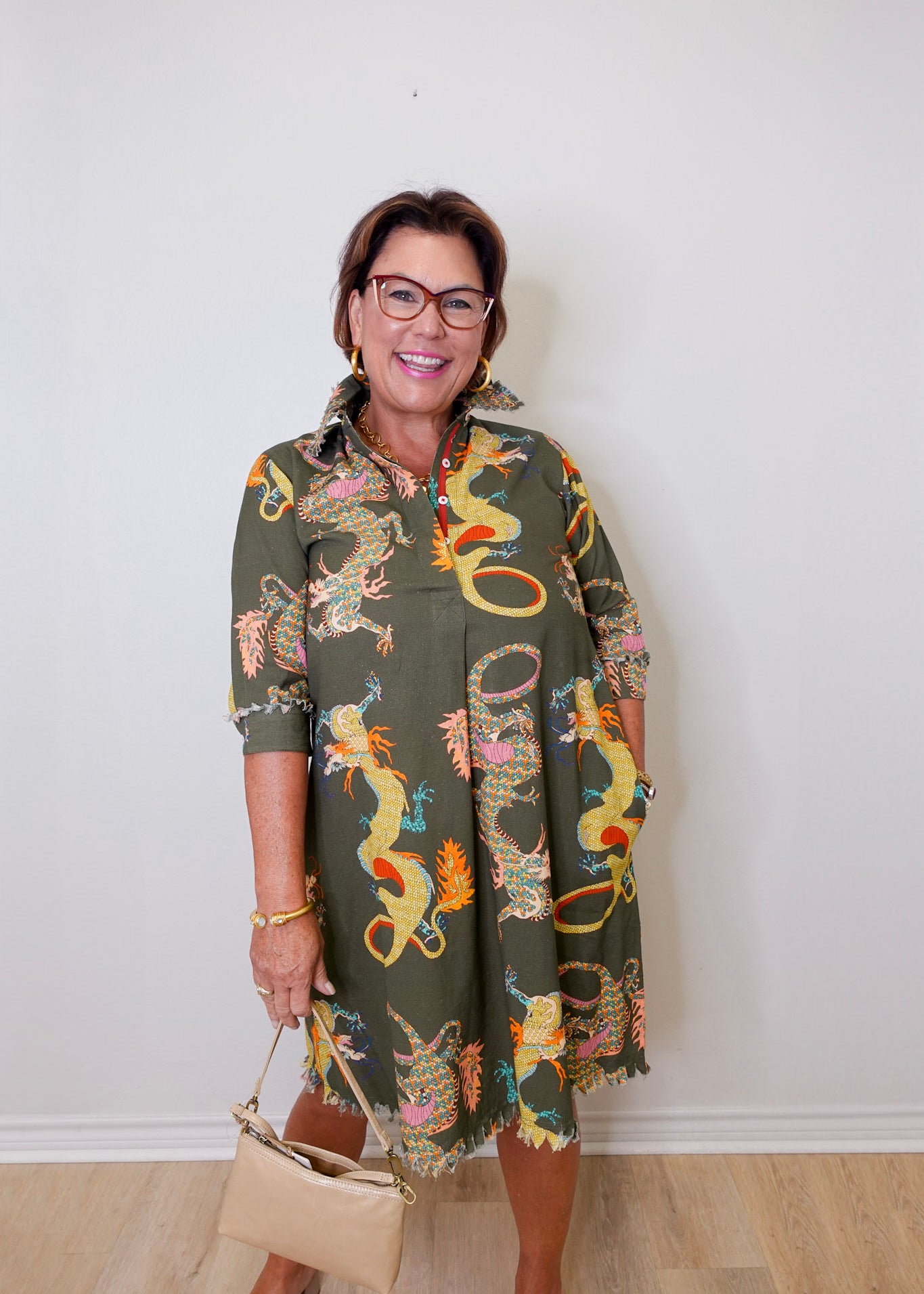 Woman wearing a patterned dress with a plain background