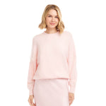 Woman wearing a light pink outfit on a white background