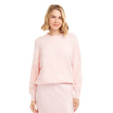 Woman wearing a light pink outfit on a white background