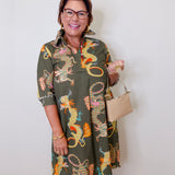 Woman wearing a patterned dress with a plain background