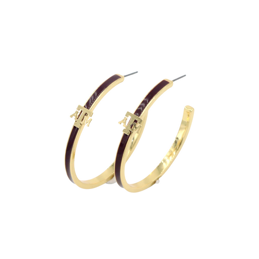 Gold hoop earrings with purple accents on a white background