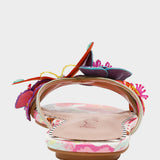 Colorful sandal with floral design on a light gray background