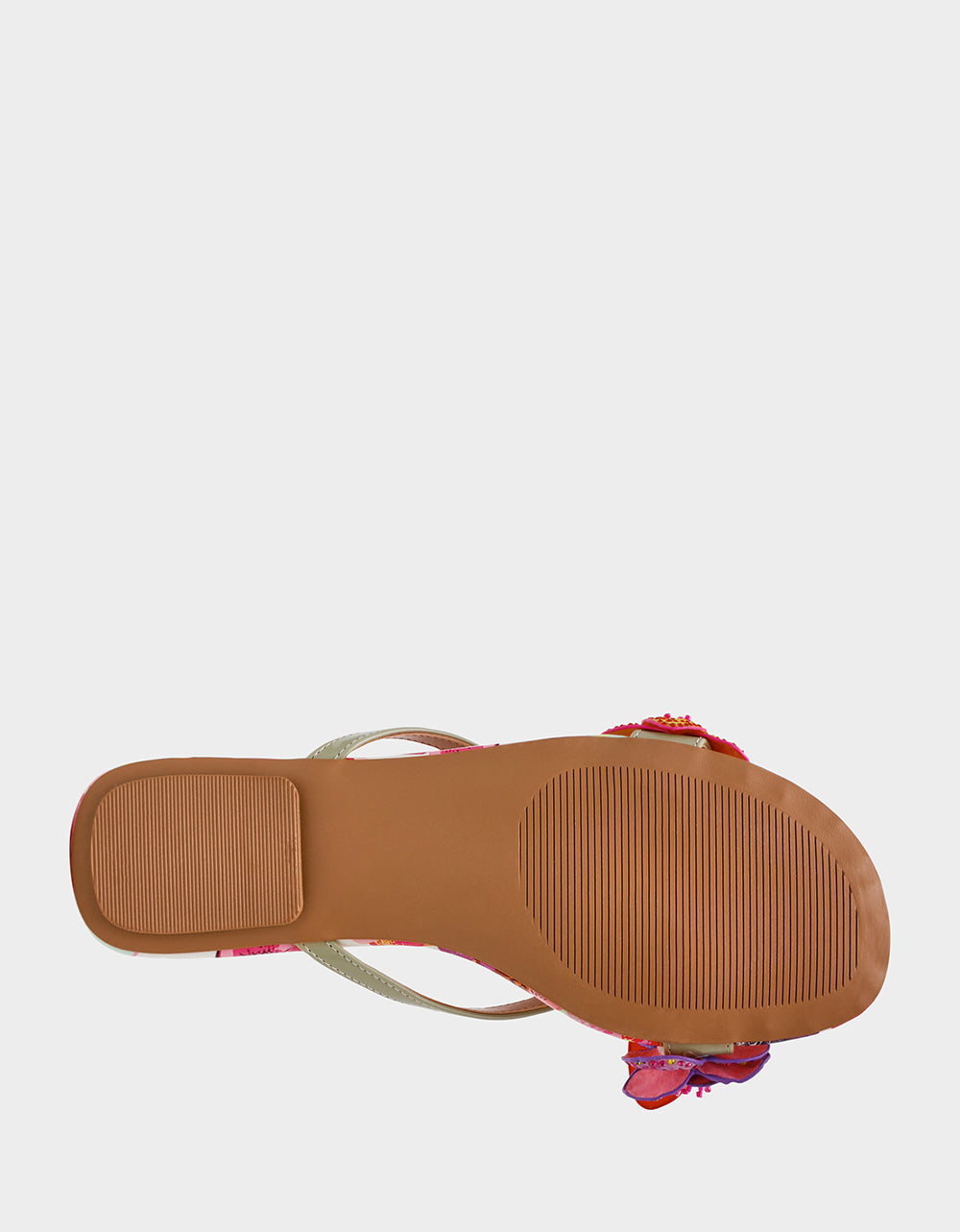 Close-up of a sandal with a floral strap on a white background