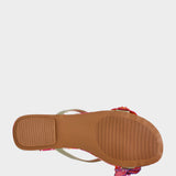 Close-up of a sandal with a floral strap on a white background
