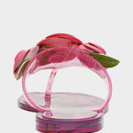 Pink sandals with floral design on a light gray background
