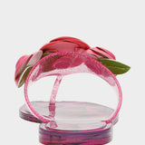 Pink sandals with floral design on a light gray background