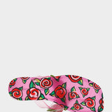 Pink sandal with red rose pattern on a white background