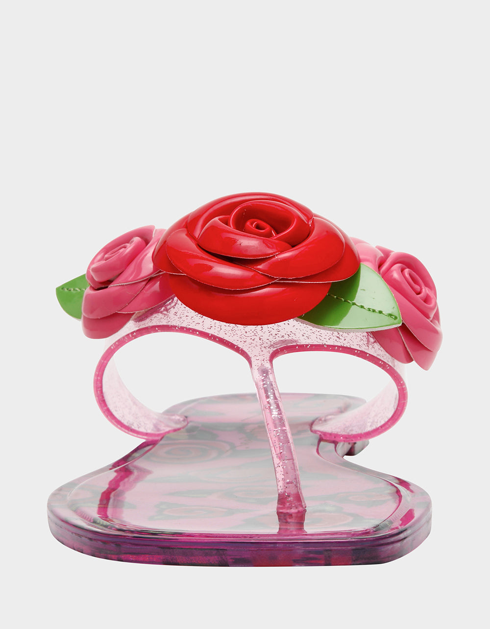 Clear sandal with pink and red floral decorations on a white background