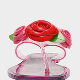 Clear sandal with pink and red floral decorations on a white background