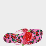 Pink sandal with floral design and red rose on a white background
