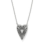 Heart-shaped pendant necklace with a sunburst design on a white background