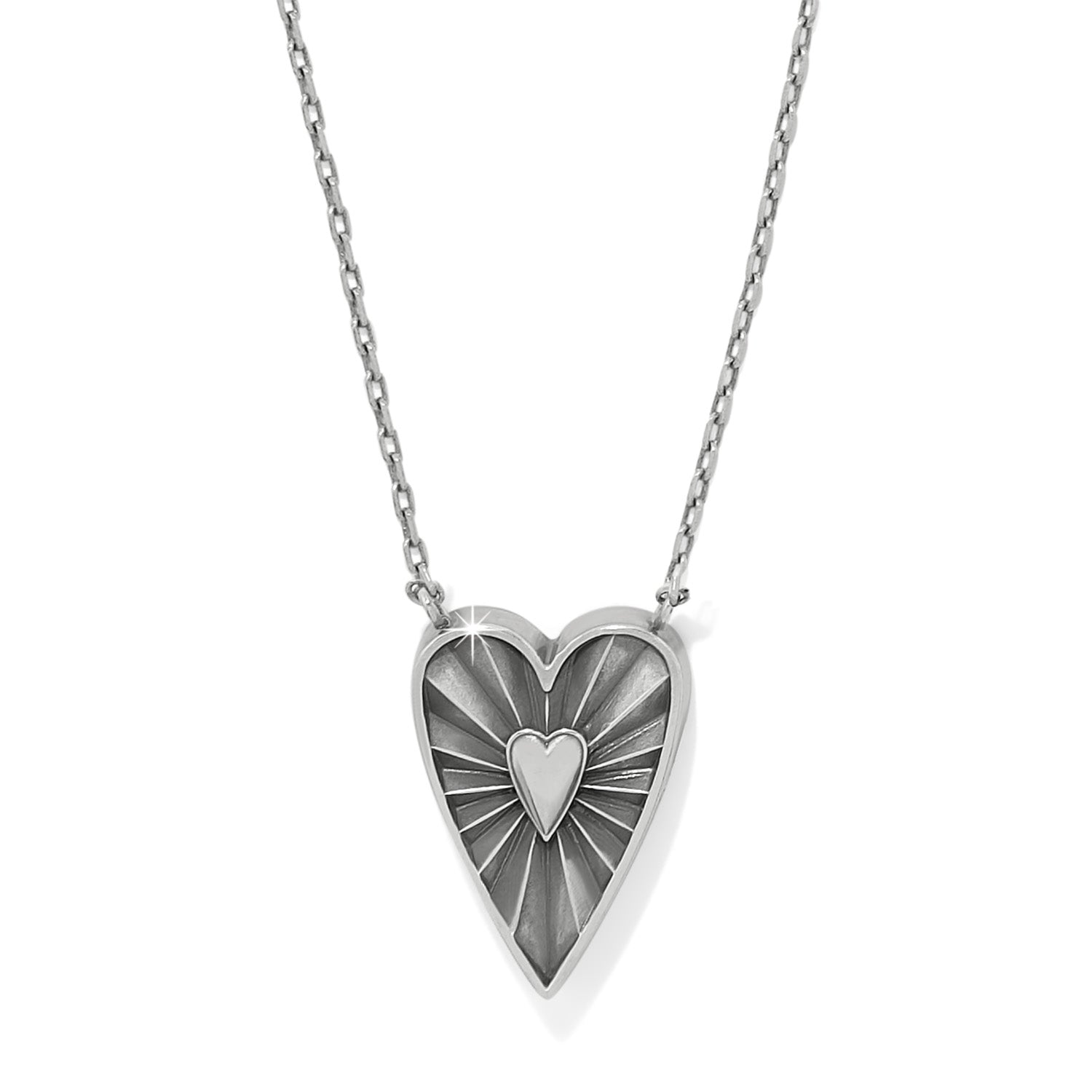 Heart-shaped pendant necklace with a sunburst design on a white background