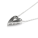 Silver necklace with a heart-shaped pendant on a white background