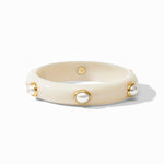 Beige bracelet with gold accents and pearl-like beads on a white background