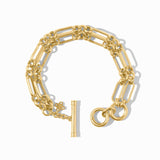 Gold bracelet with a floral charm on a white background