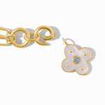 Gold bracelet with a floral charm on a white background