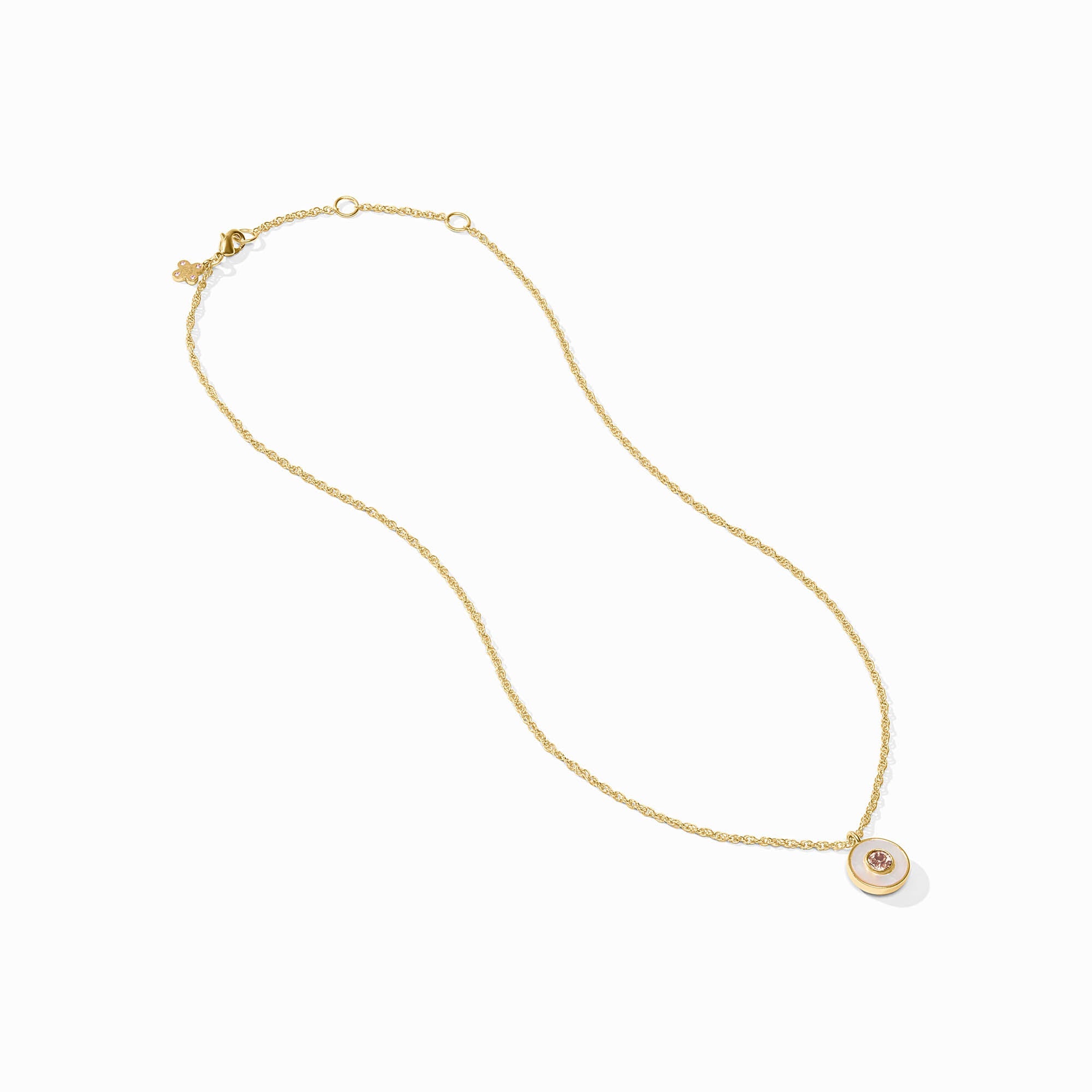 Gold necklace with a small round pendant on a white background