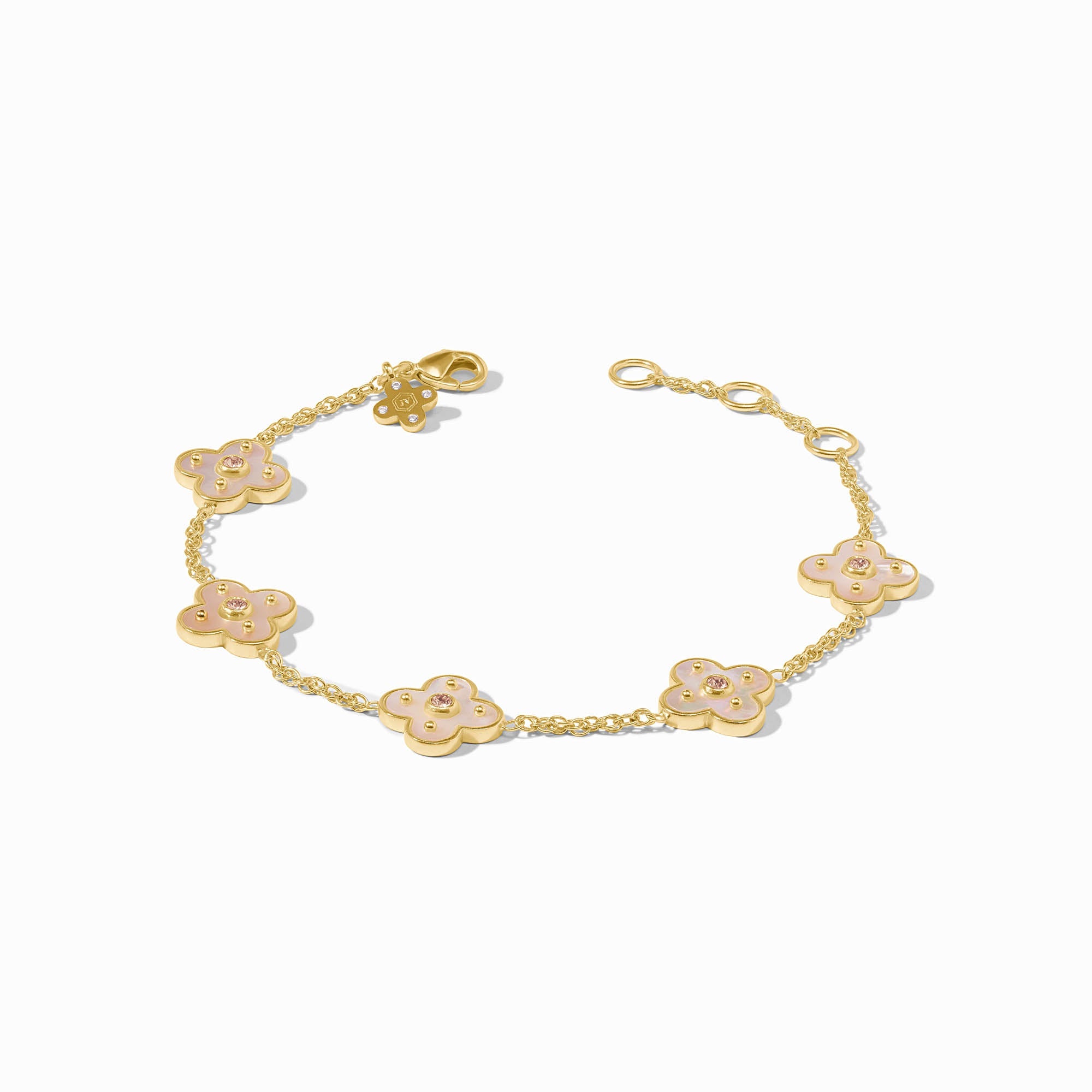 Gold bracelet with floral designs on a white background