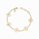 Gold bracelet with floral designs on a white background