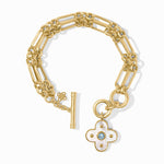 Gold bracelet with a floral charm on a white background