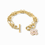 Gold bracelet with a floral charm on a white background