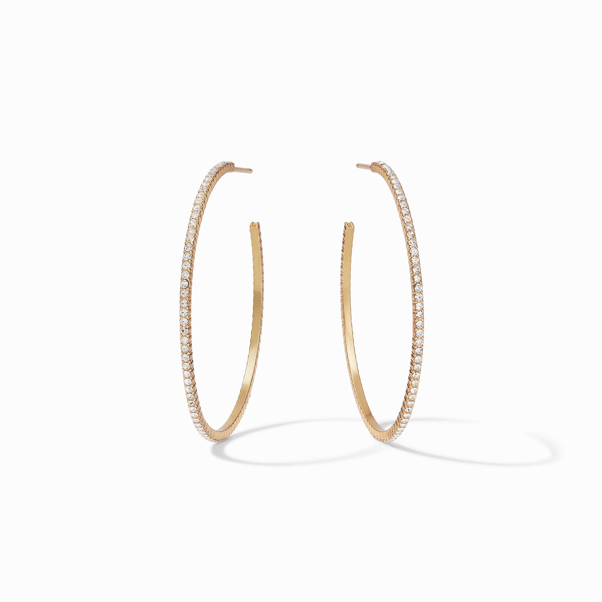Gold hoop earrings with embedded stones on a white background